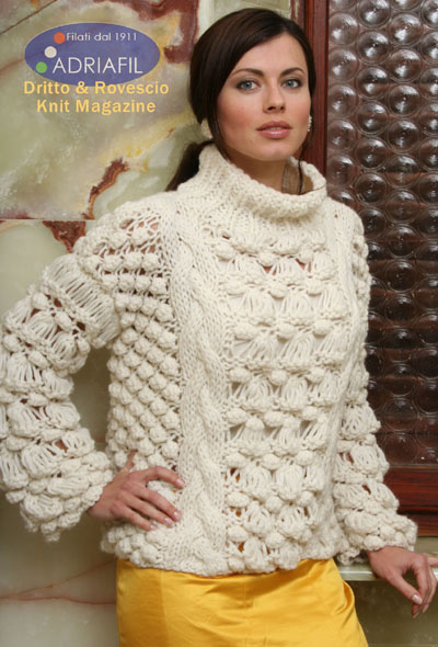 Free knitting pattern for a ladies sweater in chunky yarn with cable and bobble stitch details and a turtleneck.