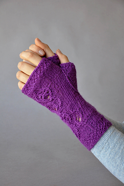 Free Knitting Pattern for Flight of Fancy Mitts. These delicate mitts are knit in the round from the cuff upward. Twist-stitch leaves on a background of reverse stockinette stitch are mirrored on right and left hands. 