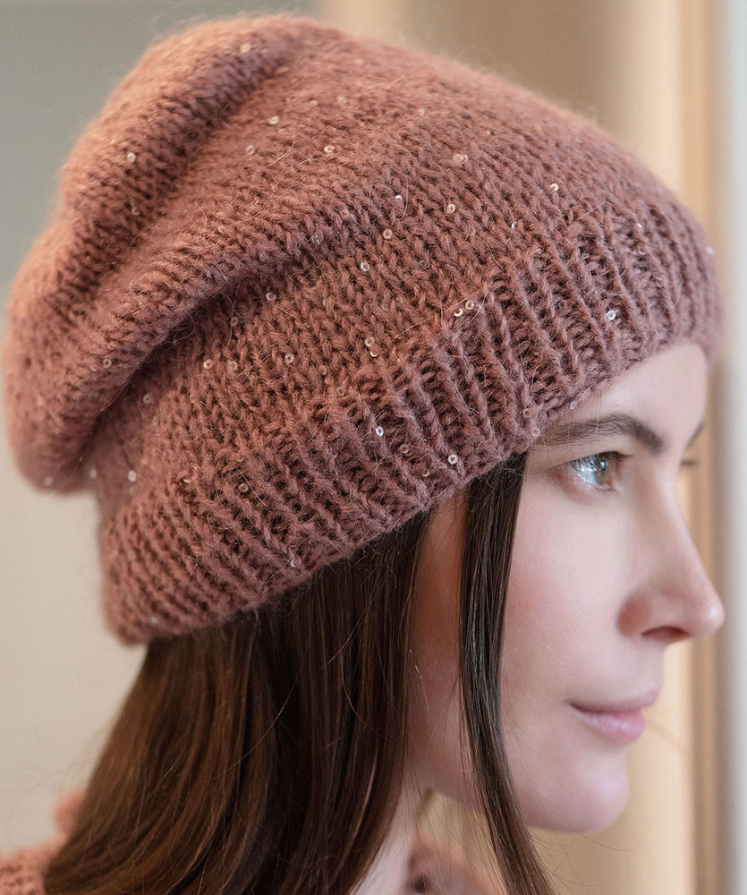 Free Knitting Pattern for a Beginner Beanie. Beginner beanie to knit for ladies in stockinette stitch with a rib stitch edge.