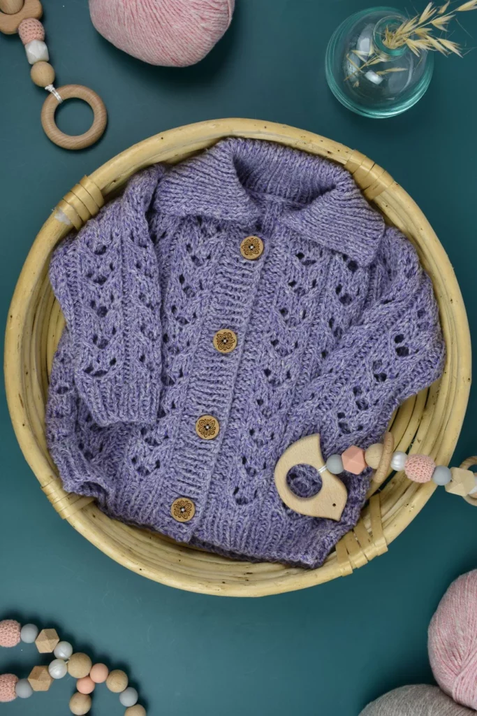 an all over lace knit baby cardigan with lavender yarn