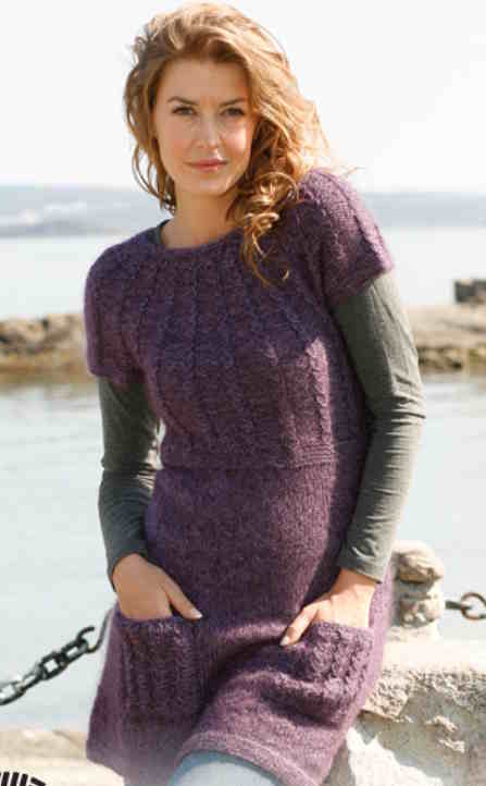 Purple garter stitch yoke dress with simple cables and pockets.